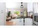 Modern kitchen with white cabinets, a center island and granite countertops at 10420 Marion St, Northglenn, CO 80233