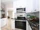 Modern kitchen with stainless steel appliances, granite countertops and white cabinets at 10420 Marion St, Northglenn, CO 80233
