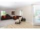 An open floor plan showcases the living room and access to the sun room at 10420 Marion St, Northglenn, CO 80233