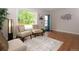 Cozy living room featuring hardwood floors, a large window, and stylish decor at 10420 Marion St, Northglenn, CO 80233