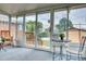 Bright sunroom with full glass windows offering views of the backyard at 10420 Marion St, Northglenn, CO 80233