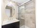 Basement bathroom with updated vanity and glass shower at 1669 S De Gaulle Way, Aurora, CO 80018