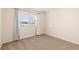 Well-lit bedroom featuring carpeted floors and window with curtains at 1669 S De Gaulle Way, Aurora, CO 80018