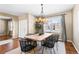 Dining area with a rustic wood table, black chairs, and a chandelier at 1669 S De Gaulle Way, Aurora, CO 80018