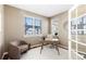 Bright home office with hardwood floors, a desk, and built-in shelving at 1669 S De Gaulle Way, Aurora, CO 80018