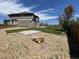 Landscaped backyard with a stone area and lawn, perfect for outdoor activities and relaxation at 3508 Silverado Cir, Frederick, CO 80516