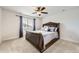 Cozy bedroom with decorative window coverings, ceiling fan and comfortable carpeting at 3508 Silverado Cir, Frederick, CO 80516