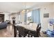 Bright dining area features stylish chandelier, large windows, and seamless flow to the living area at 3508 Silverado Cir, Frederick, CO 80516