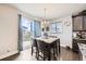 Dining area includes a modern table and chairs, with a view of the backyard at 3508 Silverado Cir, Frederick, CO 80516