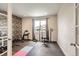 Home gym features workout equipment, rubber flooring, and a window with natural light at 3508 Silverado Cir, Frederick, CO 80516