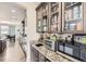 Kitchenette features glass-front cabinets, modern appliances, and granite countertops at 3508 Silverado Cir, Frederick, CO 80516