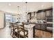 Modern kitchen with a large island, granite countertops, and stainless steel appliances at 3508 Silverado Cir, Frederick, CO 80516