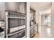 Additional kitchen space features a microwave, oven, wine cooler, and glass-front cabinets at 3508 Silverado Cir, Frederick, CO 80516