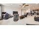 Spacious living room featuring plush carpet, ceiling fan, and comfortable seating arrangement at 3508 Silverado Cir, Frederick, CO 80516