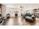 Bright living room with hardwood floors, fireplace, and ample seating at 3508 Silverado Cir, Frederick, CO 80516