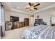 Main bedroom offers ample space with a ceiling fan, carpeting, and ensuite bathroom access at 3508 Silverado Cir, Frederick, CO 80516