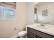 Clean powder room features a modern vanity, a toilet and a window with natural light at 3508 Silverado Cir, Frederick, CO 80516