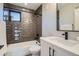 Bathroom with modern fixtures, vanity, tub, and shower; tiled with grey subway tiles at 3911 Mariposa St, Denver, CO 80211