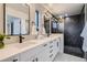 Modern bathroom featuring double sinks, sleek black fixtures, and a stylish black marble shower at 3911 Mariposa St, Denver, CO 80211