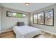 Bright bedroom featuring wood floors, a comfortable bed and large windows offering ample natural light at 3911 Mariposa St, Denver, CO 80211