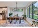 Elegant dining area featuring a modern light fixture, hardwood floors, and natural light at 3911 Mariposa St, Denver, CO 80211
