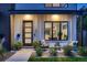 Charming front porch with seating, decorative plants, and a modern front door enhances curb appeal at 3911 Mariposa St, Denver, CO 80211