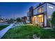 Well-manicured front yard and modern home with a rooftop deck offer city views at 3911 Mariposa St, Denver, CO 80211