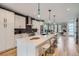 Modern kitchen with white cabinets, stainless steel appliances, and a large island at 3911 Mariposa St, Denver, CO 80211
