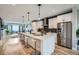 Open kitchen with a center island, bar stool seating, and stainless steel appliances at 3911 Mariposa St, Denver, CO 80211