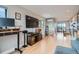Spacious living area with media center and wood floors leads to an exterior patio at 3911 Mariposa St, Denver, CO 80211