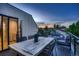 Relax on the cozy deck with comfortable outdoor seating, perfect for enjoying the sunset views at 3911 Mariposa St, Denver, CO 80211