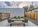 Outdoor patio features a wooden table and chairs, complemented by modern siding and a well-maintained wooden fence at 3911 Mariposa St, Denver, CO 80211