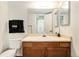 Clean bathroom with wood vanity, toilet and mirror at 8402 Everett Way # B, Arvada, CO 80005