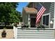 Gray house with American flag, flower planters, and a well-maintained yard at 8402 Everett Way # B, Arvada, CO 80005