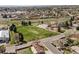 Aerial view of a neighborhood featuring mature trees, a park, and walking trail at 10769 Murray Dr, Northglenn, CO 80233