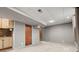 Finished basement features neutral carpet, wet bar area, and access to stairs at 10769 Murray Dr, Northglenn, CO 80233