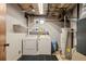 Basement laundry area featuring washer, dryer and water heater at 10769 Murray Dr, Northglenn, CO 80233