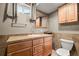Bathroom features a tile floor and a wooden vanity at 10769 Murray Dr, Northglenn, CO 80233