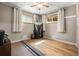 Bright bedroom features hardwood floors, neutral paint, and natural light streaming through the windows at 10769 Murray Dr, Northglenn, CO 80233