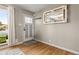 Light-filled entryway with hardwood floors, a decorative mirror, and a charming front door at 10769 Murray Dr, Northglenn, CO 80233