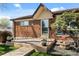 Close-up of the front porch with a brick facade and decorative potted plants at 10769 Murray Dr, Northglenn, CO 80233