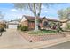 Charming brick home featuring a well-maintained front yard, mature tree and detached garage at 10769 Murray Dr, Northglenn, CO 80233