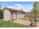 Exterior view of the detached garage and a well-maintained backyard with lush lawn at 10769 Murray Dr, Northglenn, CO 80233