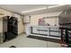 Well-equipped garage featuring storage solutions, a refrigerator, and a sturdy workbench at 10769 Murray Dr, Northglenn, CO 80233