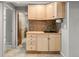 Basement kitchenette featuring wooden cabinets, tile backsplash, and a sink at 10769 Murray Dr, Northglenn, CO 80233