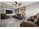 Cozy living room with plush seating, a ceiling fan, and a large flat-screen TV at 10769 Murray Dr, Northglenn, CO 80233