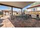 Covered outdoor patio with tiled flooring and metal dining set, perfect for entertaining at 10769 Murray Dr, Northglenn, CO 80233