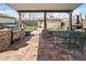 Relaxing covered patio features a built-in grill, outdoor seating, and charming backyard views at 10769 Murray Dr, Northglenn, CO 80233