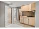 Basement wet bar area featuring wooden cabinets and tile backsplash at 10769 Murray Dr, Northglenn, CO 80233