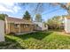 Back exterior view of home with shed, covered patio, and lawn at 3430 N Clayton St, Denver, CO 80205